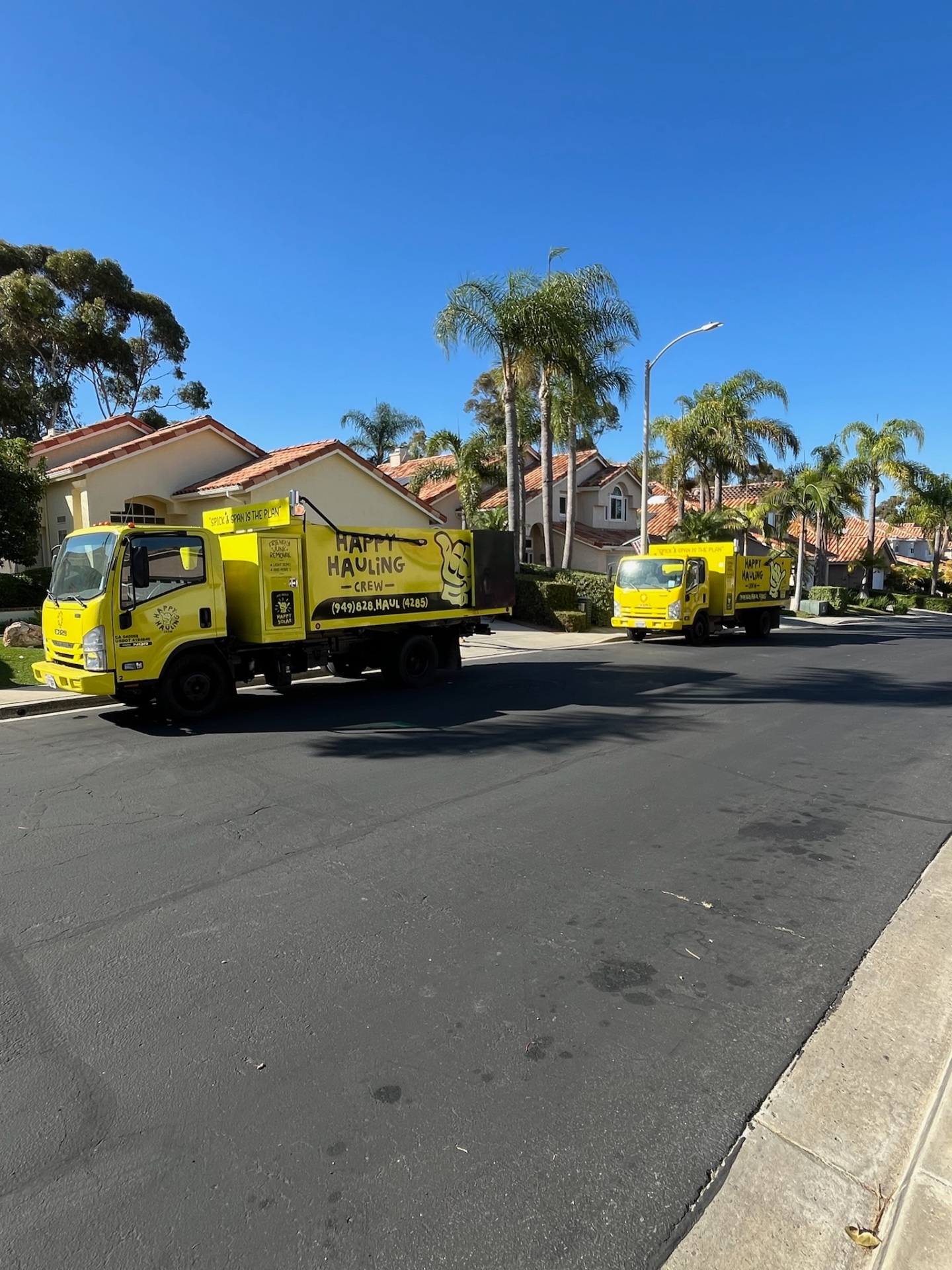 Happy Hauling Crew fleet -- two trucks ready for big jobs